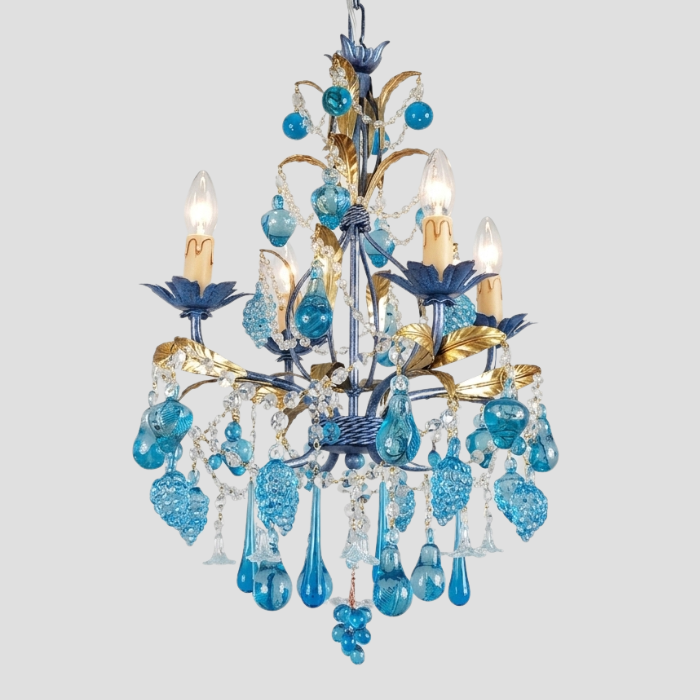 A cerulean blue and gold multi-light chandelier with glass teardrop pendants and clear crystal accents, shown against a solid light gray background.