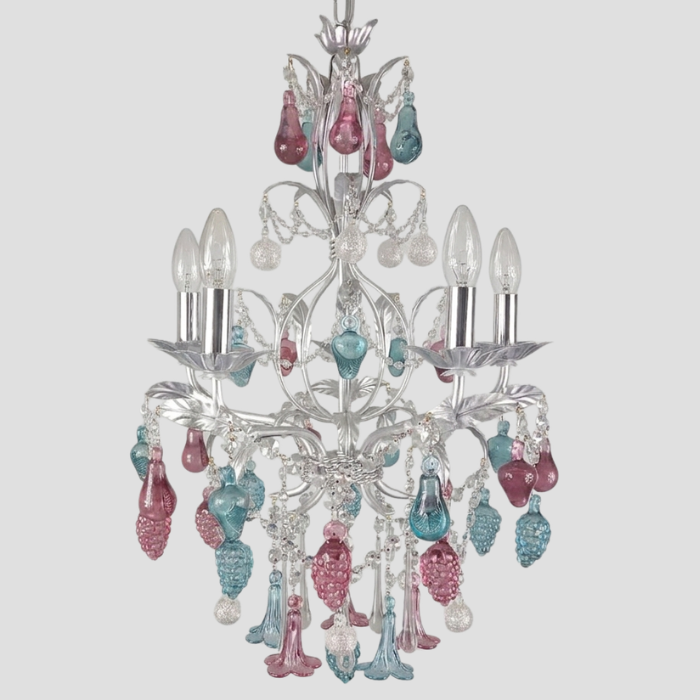 A silver-toned five-light chandelier featuring dangling teardrop-shaped glass accents in ruby, emerald, and silver, shown against a solid light gray background.