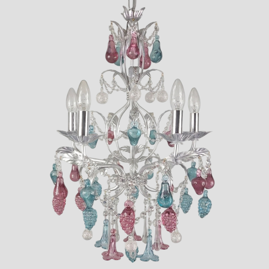A silver-toned five-light chandelier featuring dangling teardrop-shaped glass accents in ruby, emerald, and silver, shown against a solid light gray background.